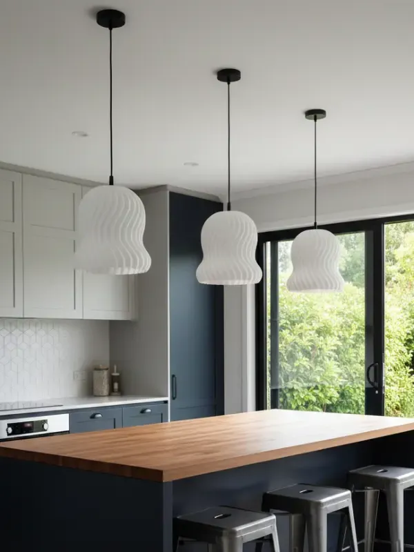 Three Tress Pendant Lights above kitchen island