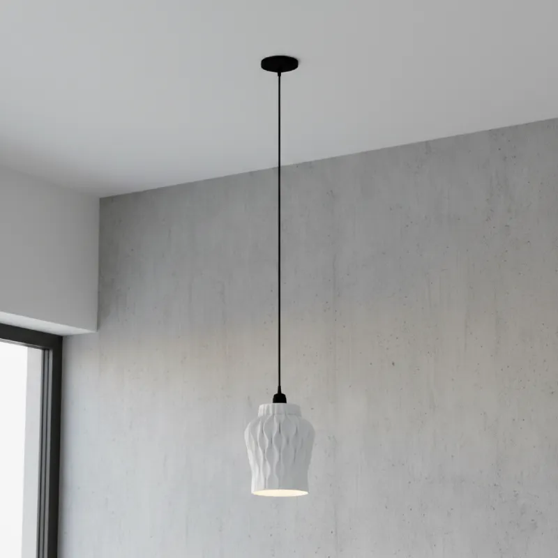 Persia pendant light attached to the ceiling, against a concrete wall